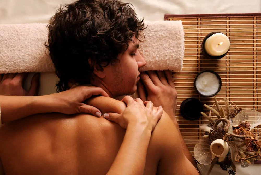 Man receiving massage therapy treatment by registered massage therapist at Therapeutic Streams in Oshawa
