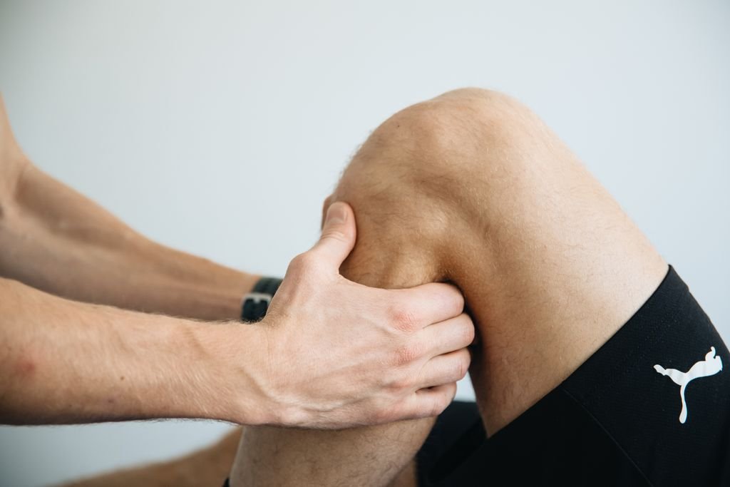 Physiotherapy session focusing on knee massage treatment.